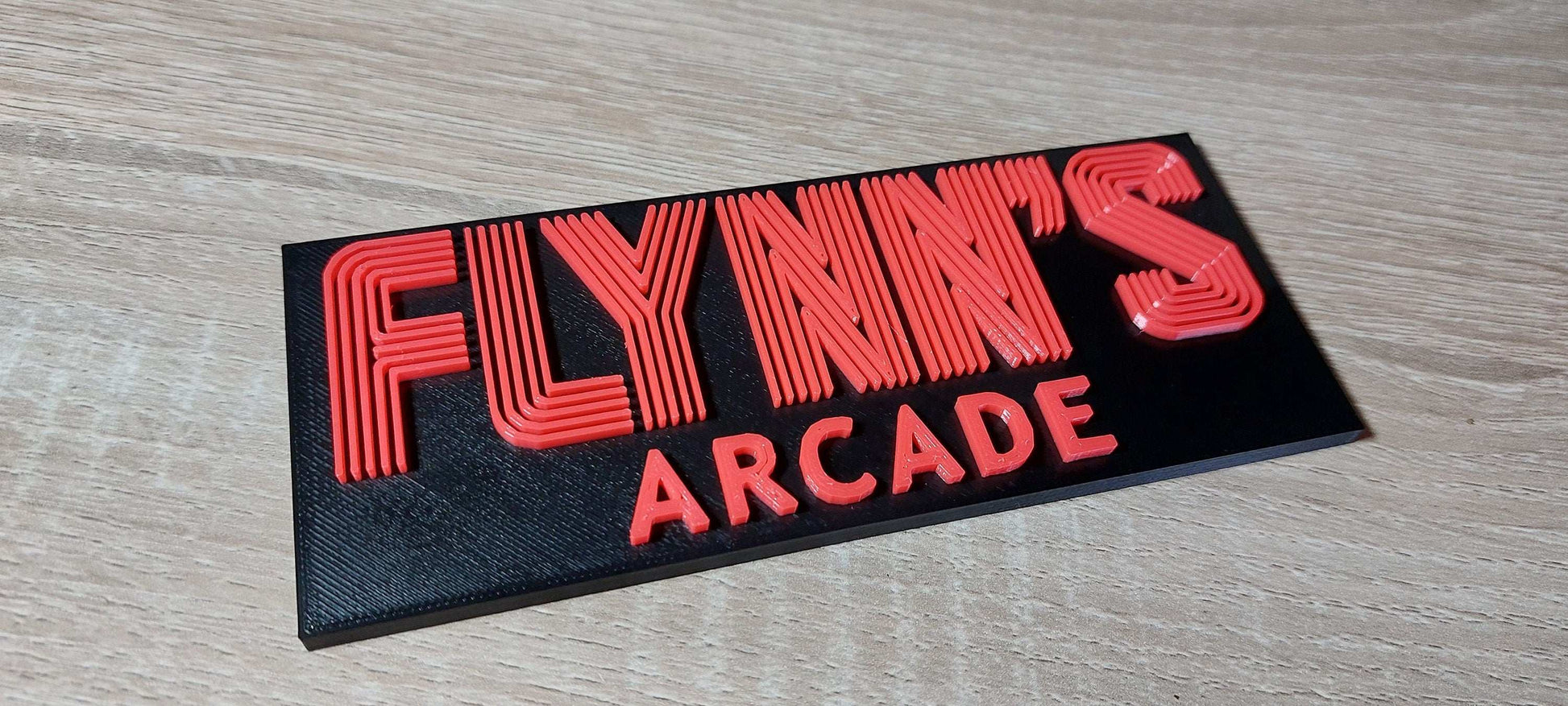 Flynn’s Arcade Tron 1982 Logo Sign – Classic Sci-Fi Movie Collectible for Retro Gaming Fans. - 3DEvricPrinting
